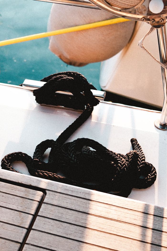 Coiled rope on a yacht deck during a sunny day in Sığacık, İzmir, ideal for nautical themes.